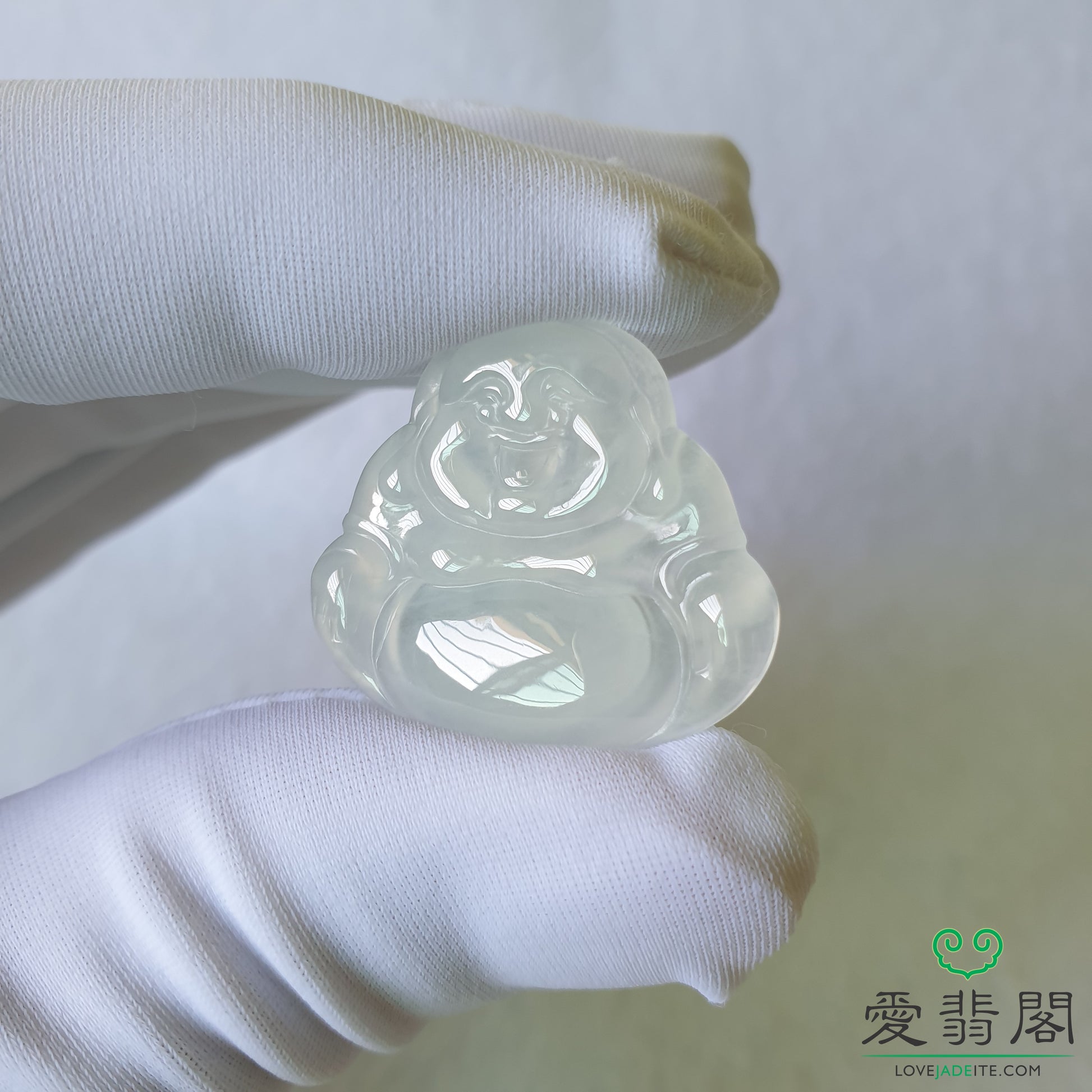 Close-up of Laughing Buddha jadeite carving showing facial details and polish